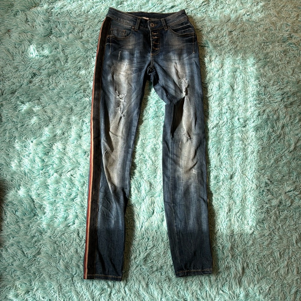 Stretchy skinny jeans with red, black and gold stripe on the side